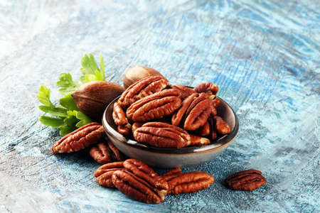 Fresh Pecan nuts on a rustic table.の写真素材