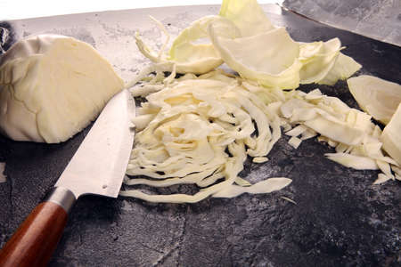 white cabbage and cutted cabbage. Prepare sliced  or cut vegetable for cooking cabbage salad or coleslaw. Homemade organic food concept.の写真素材