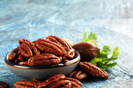Fresh Pecan nuts on a rustic table.の写真素材