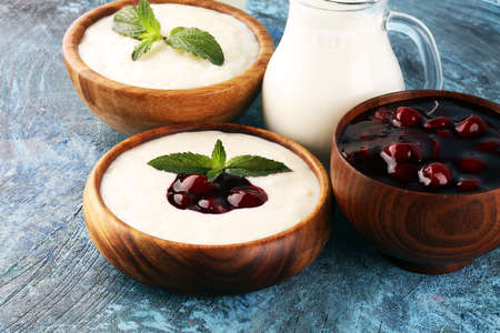 Rice porridge or milk rice pudding with syrup in a vintage bowl for a tasty breakfast.の写真素材