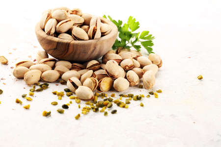 Pistachios, Roasted pistachio seeds in shells and shelled. Green, dried snack fruits, whole and chopped. の写真素材