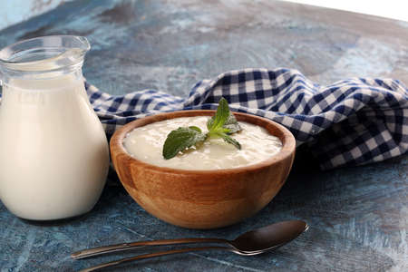 Traditional and tasty milk rice pudding with mint on rustic backgroundの写真素材