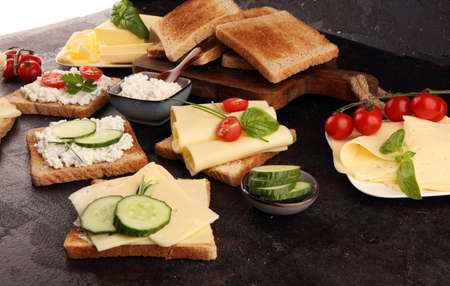 canape with yellow cheese or cream cheese and tomato. bread or toast with cheese for breakfastの写真素材