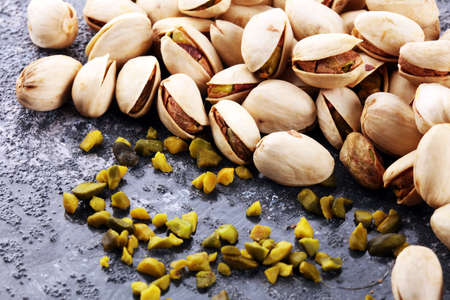 Pistachios, Roasted pistachio seeds in shells and shelled. Green, dried snack fruits, whole and chopped. の写真素材