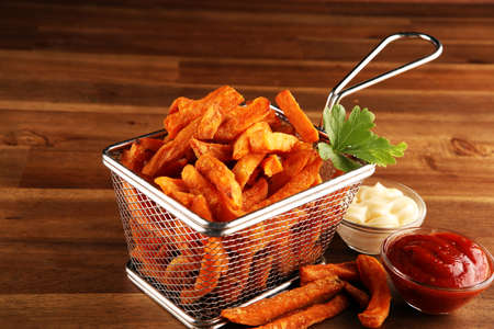 Tasty french fries on blue table backgroundの写真素材