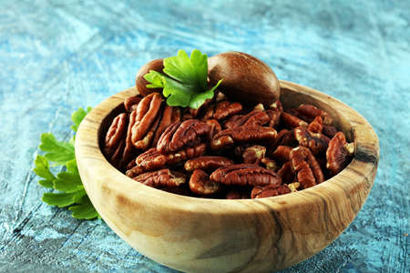 Fresh Pecan nuts on a rustic table.の写真素材