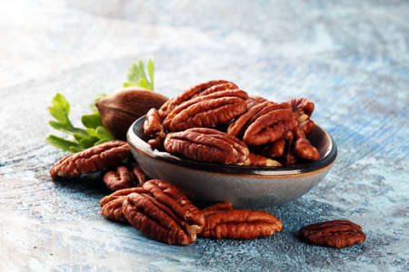 Fresh Pecan nuts on a rustic table.の写真素材