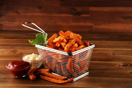 Tasty french fries on blue table backgroundの写真素材