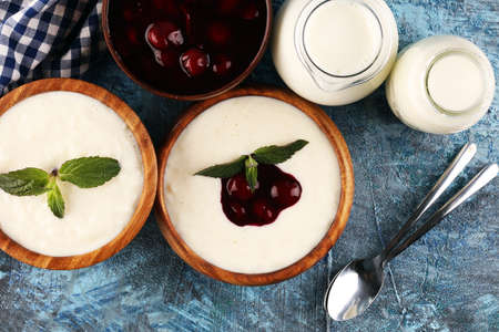 Rice porridge or milk rice pudding with syrup in a vintage bowl for a tasty breakfast.の写真素材