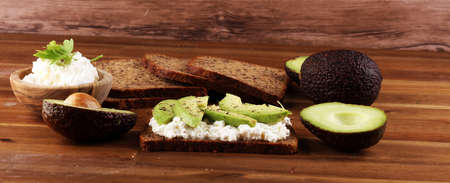 Sandwich with avocado and 
grained cream cheese for a healthy breakfast conceptの写真素材