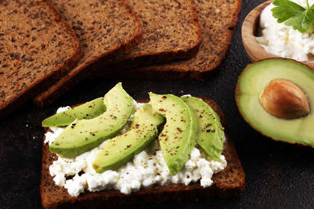 Sandwich with avocado and 
grained cream cheese for a healthy breakfast conceptの写真素材