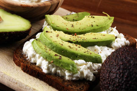 Sandwich with avocado and 
grained cream cheese for a healthy breakfast conceptの写真素材
