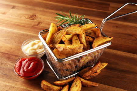Potato wedges oven roasted with fresh thyme on rustic backgroundの写真素材