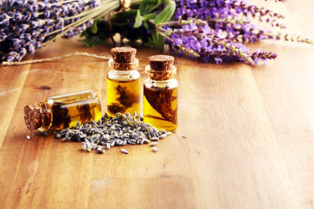lavender herbal oil and lavender flowers. bottle of lavender massage oil for aromatherapy beauty treatmentの写真素材