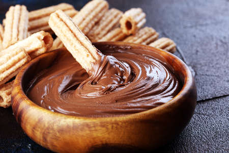 Traditional Spanish dessert churros with sugar and chocolate.の写真素材