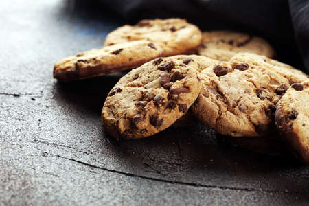 Chocolate cookies on wooden table. Chocolate chip cookies shot. Homemade food on wooden backgroundの写真素材