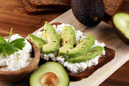 Sandwich with avocado and 
grained cream cheese for a healthy breakfast conceptの写真素材