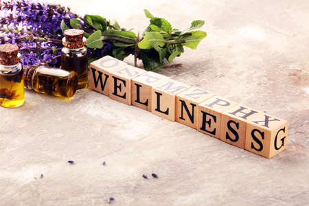 lavender herbal oil and lavender flowers. bottle of lavender massage oil for aromatherapy beauty treatment and wellness letters made of woodの写真素材