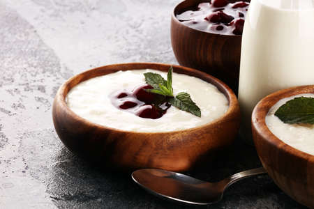 Rice porridge or milk rice pudding with syrup in a vintage bowl for a tasty breakfast.の写真素材