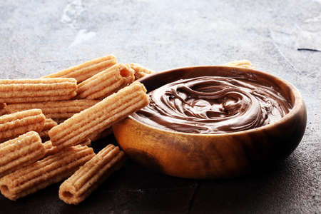 Traditional Spanish dessert churros with sugar and chocolate.の写真素材