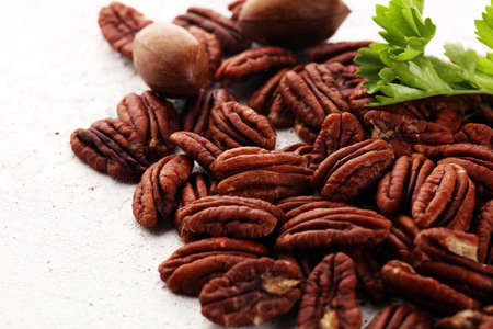 Fresh Pecan nuts on a rustic table.の写真素材