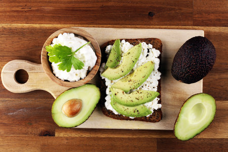 Sandwich with avocado and grained cream cheese for a healthy breakfast concept