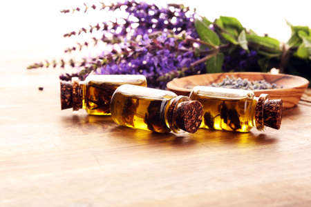lavender herbal oil and lavender flowers. bottle of lavender massage oil for aromatherapy beauty treatmentの写真素材