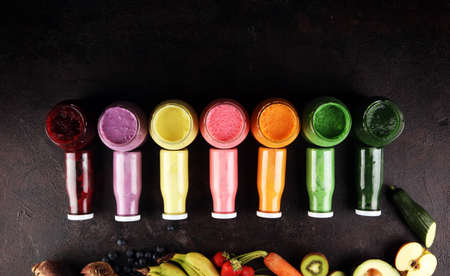Multicolored smoothies and juices from vegetables, greens, fruits and berries, healthy food background. Detox and dieting, clean eating, healthy lifestyle conceptの写真素材