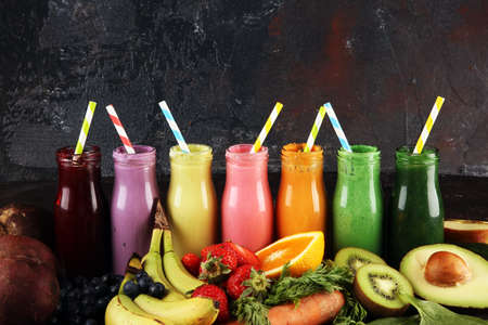 Multicolored smoothies and juices from vegetables, greens, fruits and berries, healthy food background. Detox and dieting, clean eating, healthy lifestyle conceptの写真素材