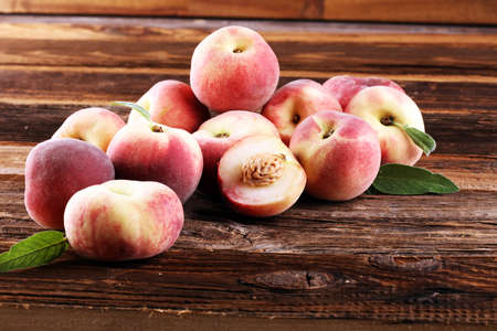 A group of ripe peaches on table. Fresh peach conceptの写真素材
