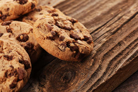 Chocolate cookies on wooden table. Chocolate chip cookies shot on woodの写真素材