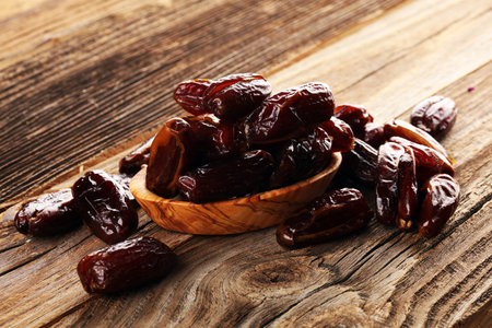 Raw Organic Medjool Dates Ready to Eat. Healthy vegetarian food on background
