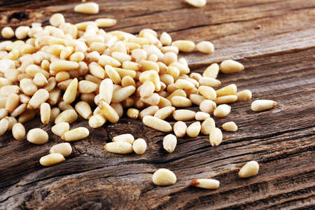 Some fresh Pine Nuts on vintage background. unshelled healthy vegetarian foodの写真素材