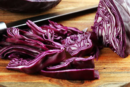 Chopped fresh red cabbage. Prepare sliced vegetable for cooking purple cabbage salad or coleslaw. Homemade fresh food concept.の写真素材