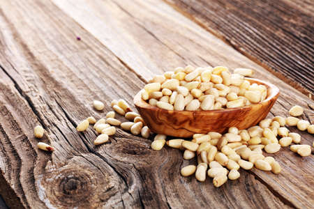 Some fresh Pine Nuts on vintage background. unshelled healthy vegetarian foodの写真素材