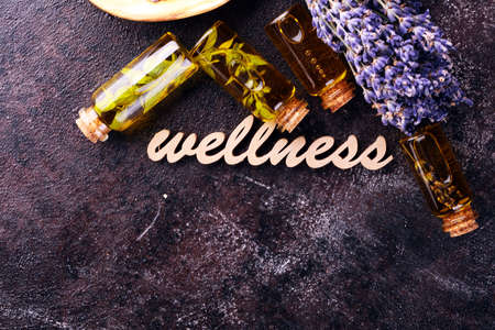 Fresh herbs from the garden and the different types of oils for massage and aromatherapy on table with lavender. Set of culinary herbs.の写真素材