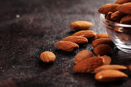 Almonds on a rustic table and almond in bowl. Healthy almondsの写真素材