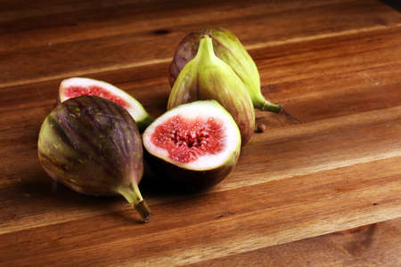 Fresh figs. Fruit with half and hole figs on background. の写真素材