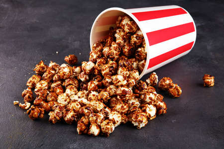 Tasty popcorn with caramel in cups on tableの写真素材