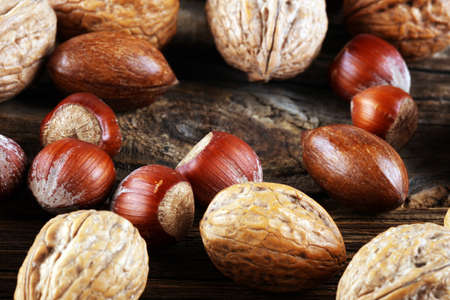 mixed nuts on grey background. Healthy food and snack. Walnut, pecan, almonds, hazelnuts. vegan healthy eatingの写真素材