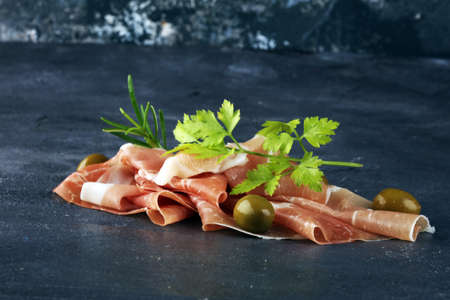 Italian prosciutto crudo or jamon with rosemary. Raw ham appetizerの写真素材