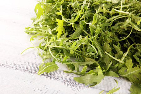 Ruccola salad on background. freshly picked arugula salad on tableの写真素材