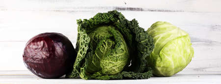 Three fresh organic cabbage heads. Antioxidant balanced diet eating with red cabbage, white cabbage and fresh savoyの写真素材