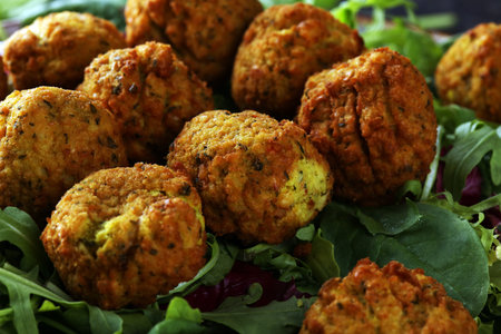 roasted falafel chickpeas patties with garlic yogurt sauce on background