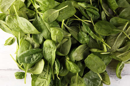 Fresh spinach leaves on rustic wooden table. healthy vegetable leafの写真素材