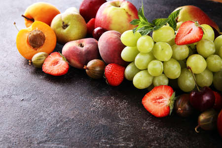 Fresh summer fruits with apple, grapes, berries, plums and organic apricot.の写真素材