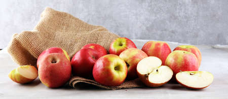 Ripe red and green apples on rustic backgroundの写真素材