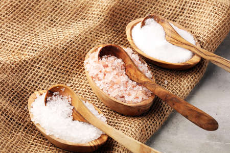 Sea salt and himalayan salt. Crystals of salt on rustic tableの写真素材