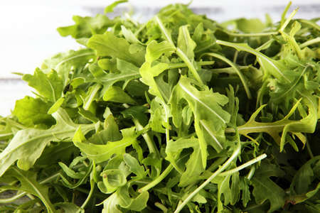 Ruccola salad on background. freshly picked arugula salad on tableの写真素材