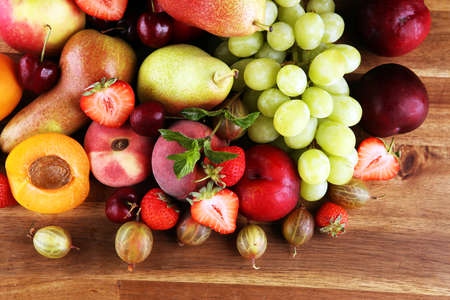 Fresh summer fruits with apple, grapes, berries, plums and organic apricot.の写真素材